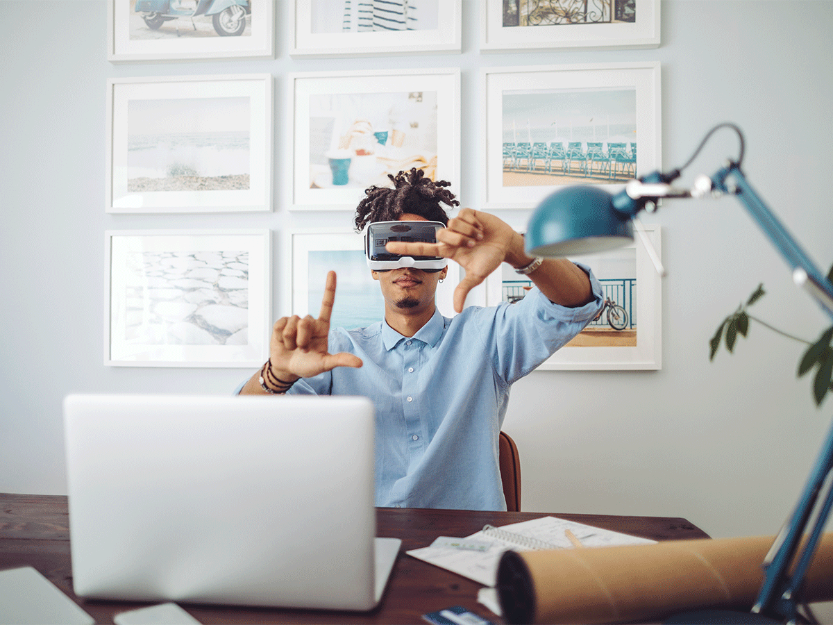 Male student using VR goggles for schoolwork