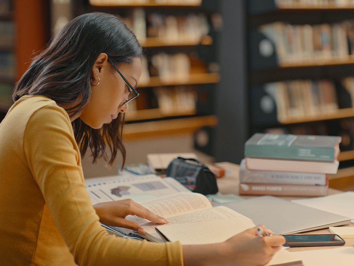 Female student studying in the library.