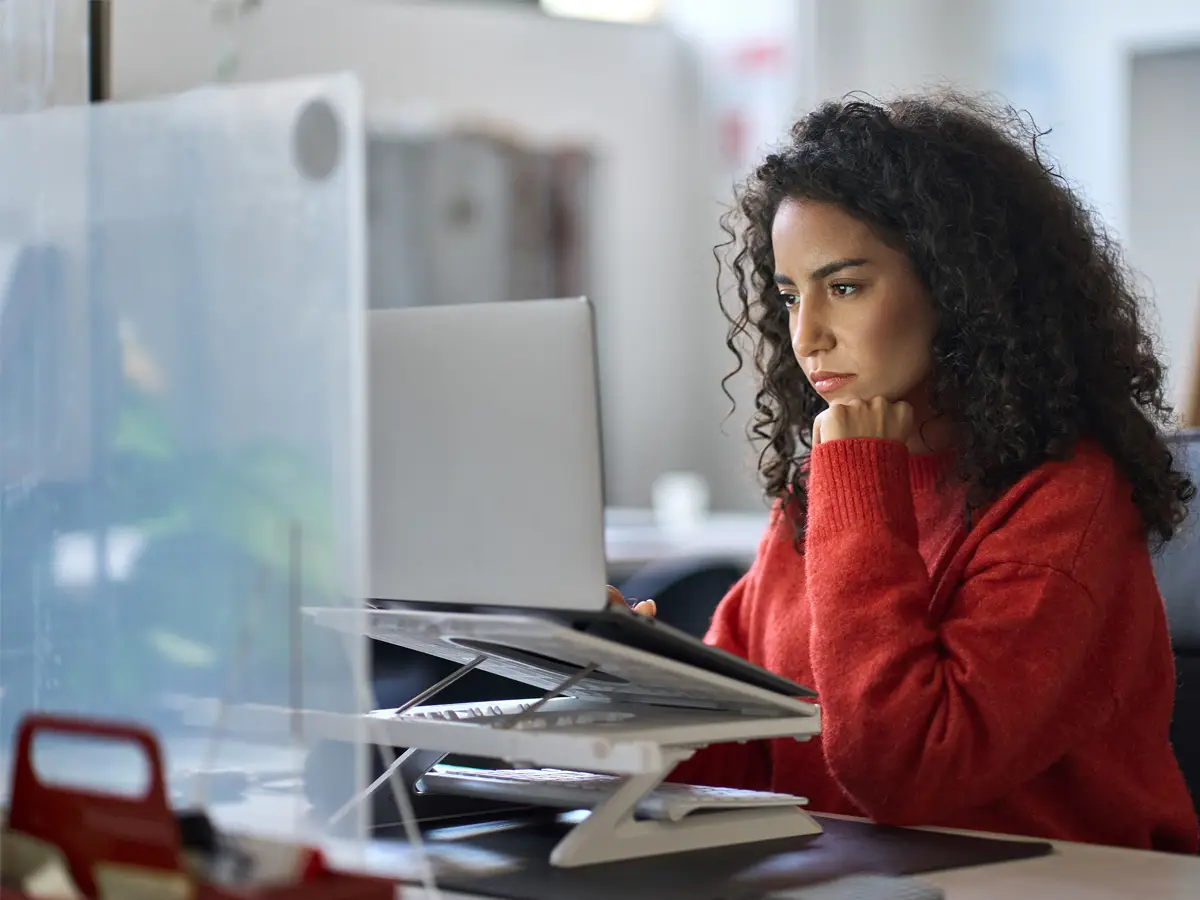 Woman intensely focused on her laptop screen
