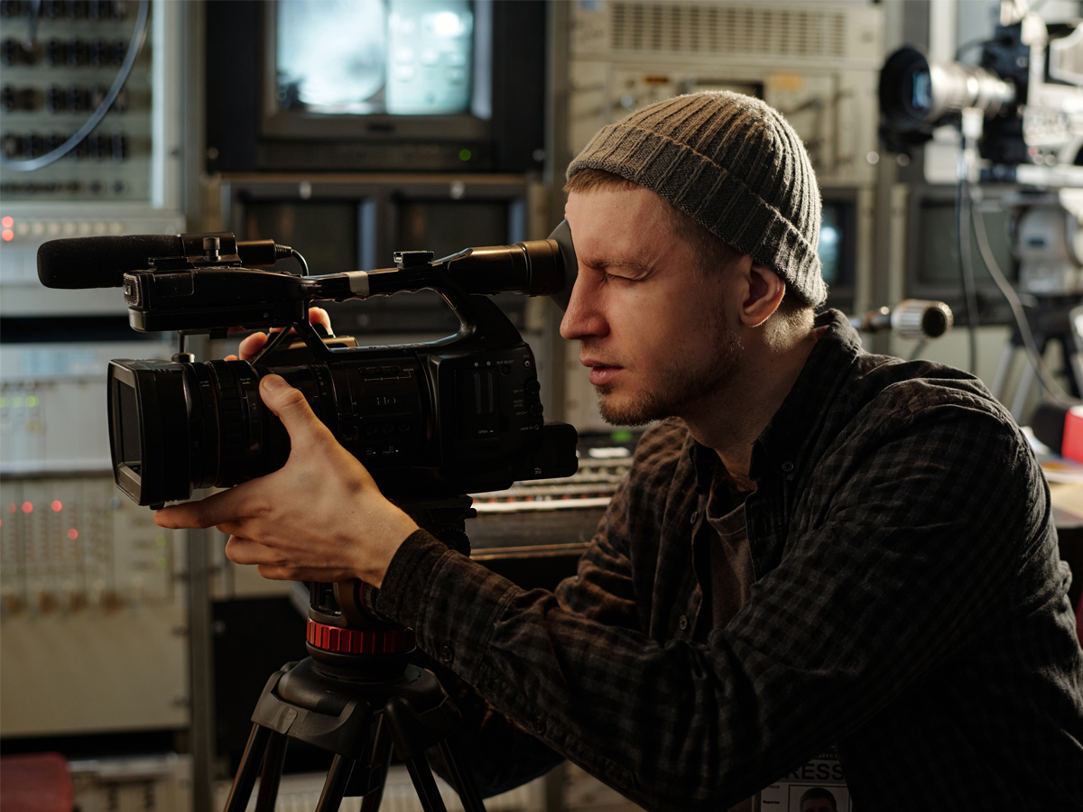 Young videographer looking into camera