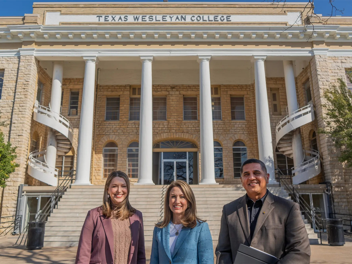 President Messer, Dr. Vaidya, and Lauren Findley Smiling infront of the Admin building