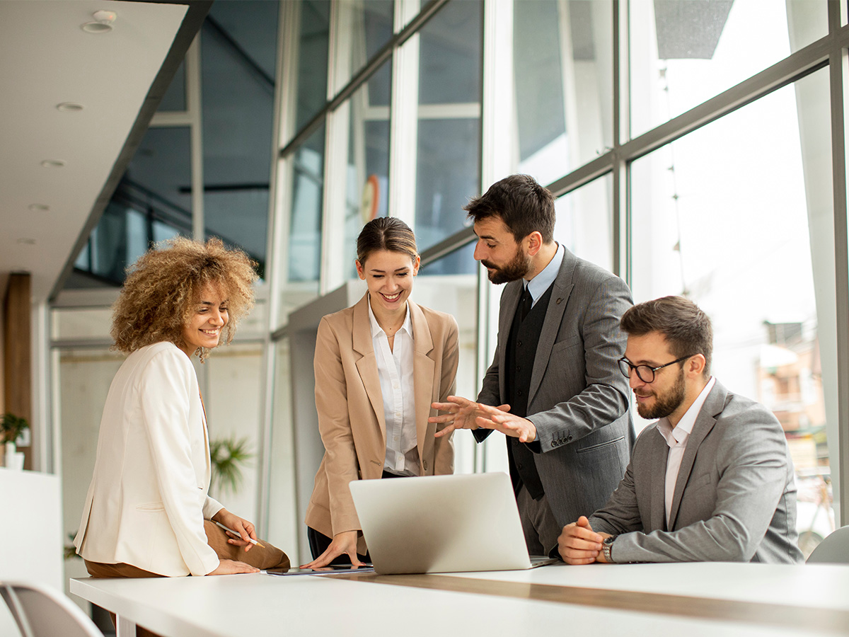 Business dressed men and women collaborating at a desk