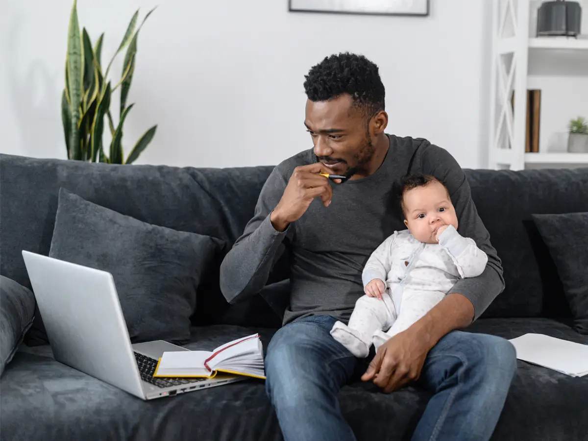 Parent holding child while while studying