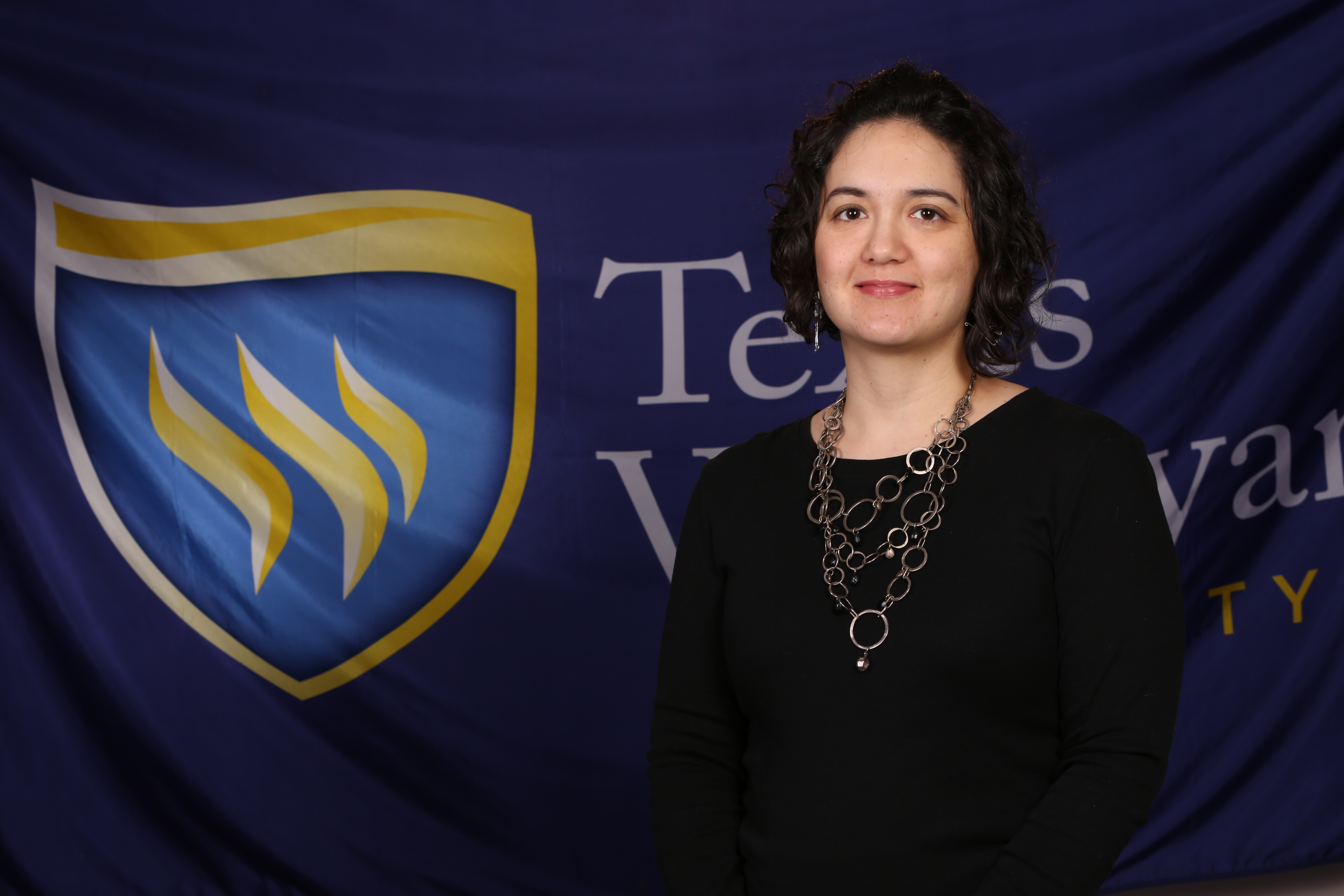 Center for Excellence in Teaching and Learning (CETL) Instructional Designer Natalie Parker with shield background