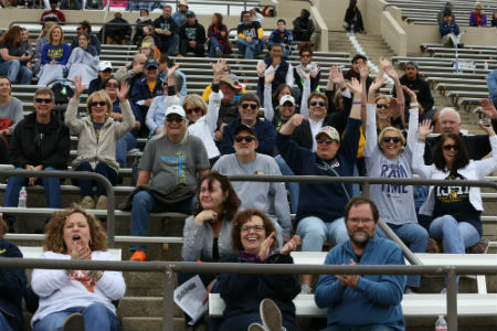 Faculty and staff cheer on the Rams at the spring Blue and Gold Scrimmage Football game on April 22, 2017