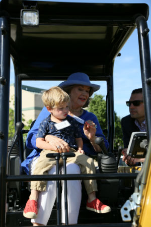Lou Martin, Texas Wesleyan donor, on a tractor with her grandson