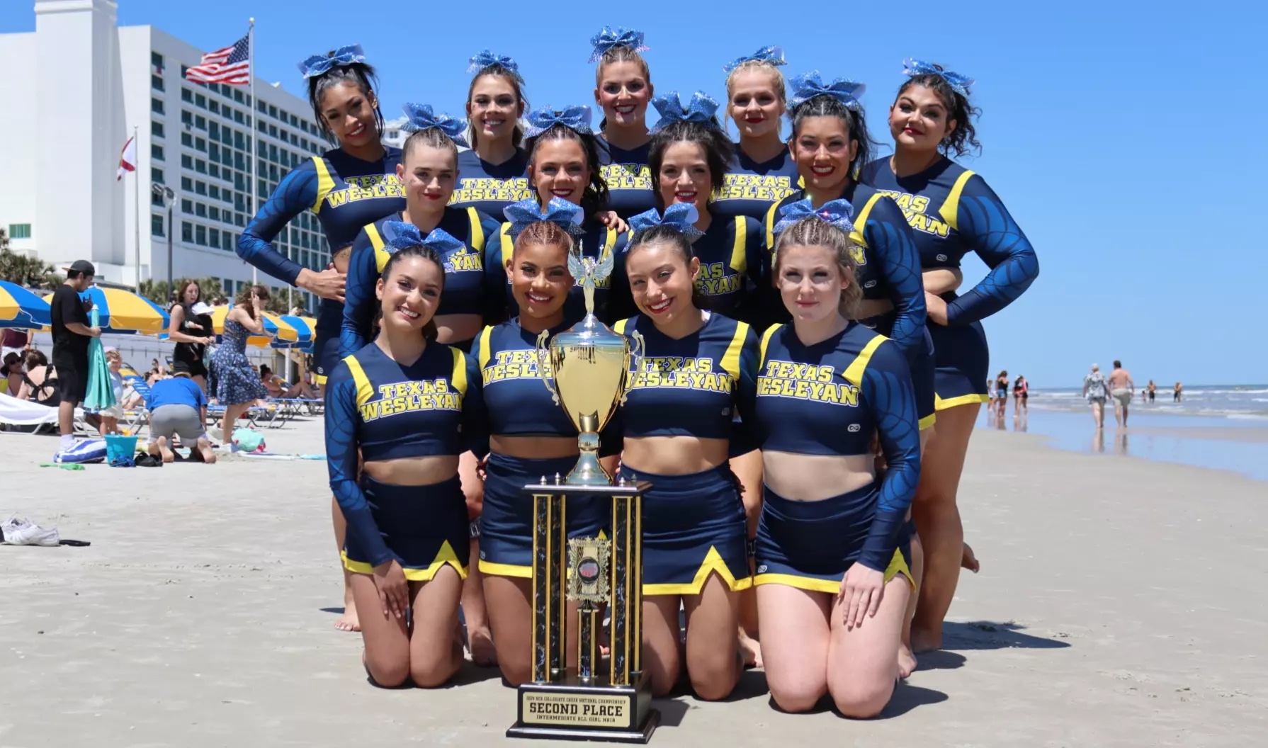 The 2024 Texas Wesleyan Cheer Team pose with their trophy in Daytona, Florida