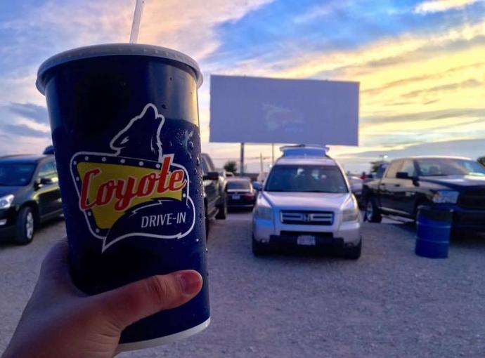 Cup held up toward screen at drive in