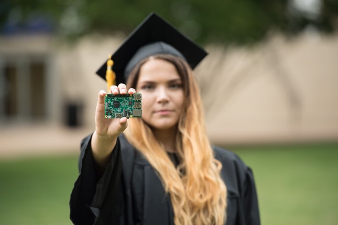 Erika Leal holds computer part from a senior project at TXWES