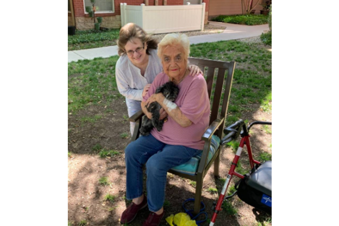 Photo of former Texas Wesleyan professor Libby Gilmore, her neighbor and her neighbor's dog.