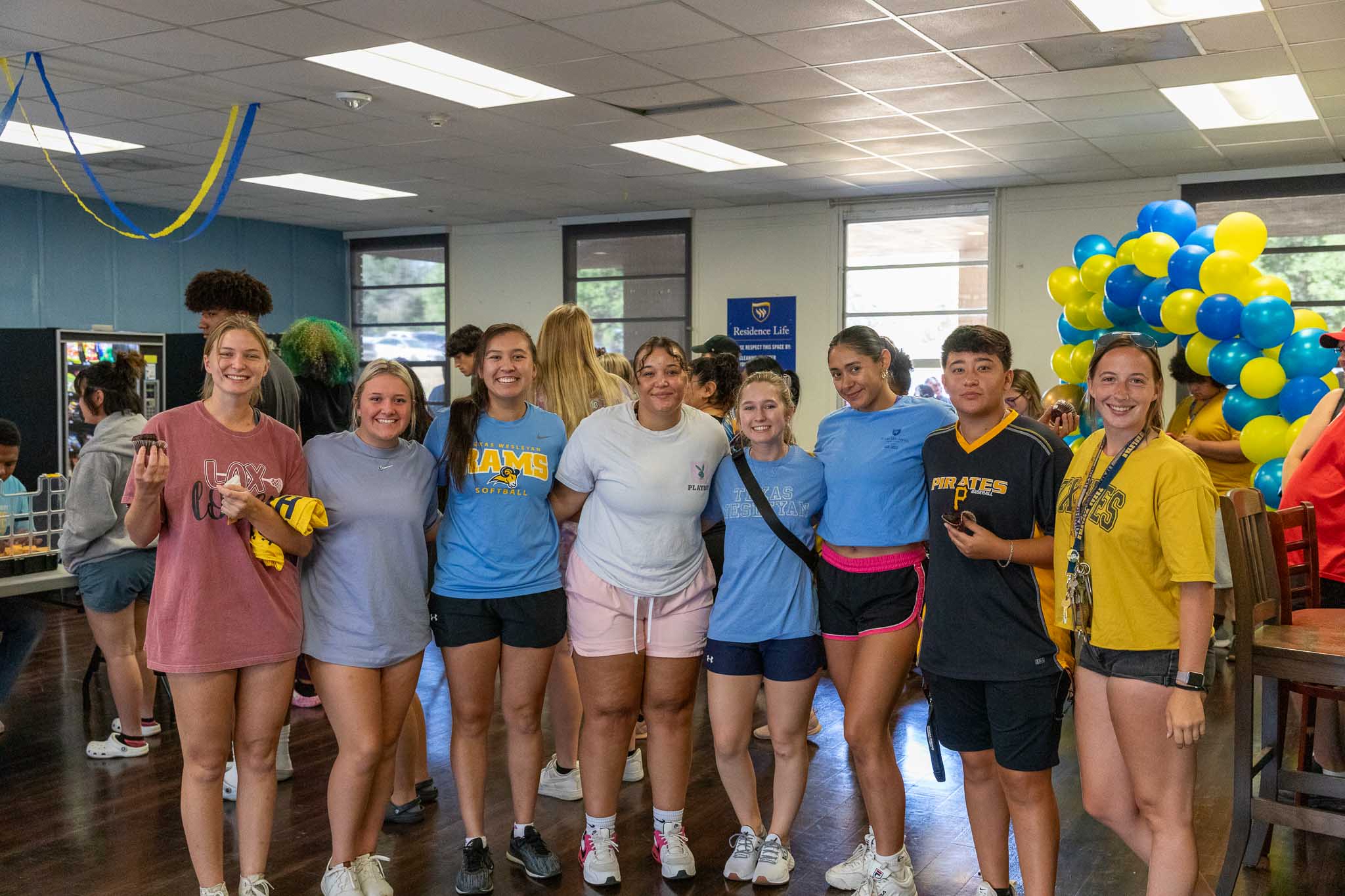 Group of students pose and smile on move in day