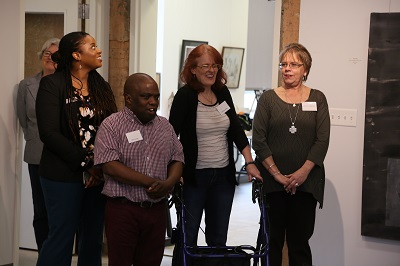 Disability Awareness Art Gallery Event welcomed Evergreen Life Services to campus.  Client's artwork was showcased in the Bernice Coulter Templeton Art Studio for purchase and display.  This photo captures administrators and clients with the Evergreen Life Services organization.      