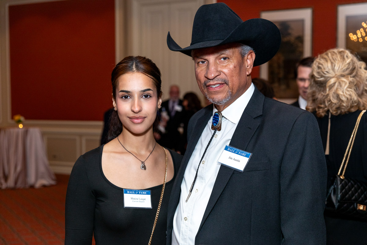 Gentleman in black cowboy hat and woman pose for a portrait