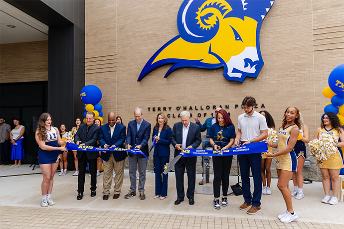 The cutting of a blue ribbon to open the Moritz field house