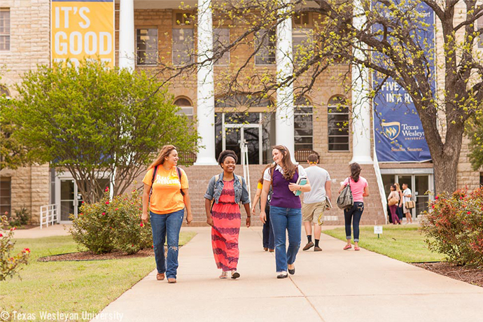students joyfully walking and conversing on campus