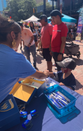 Students and Staff at the TXWES booth in downtown Fort Worth for the Michelada Festival