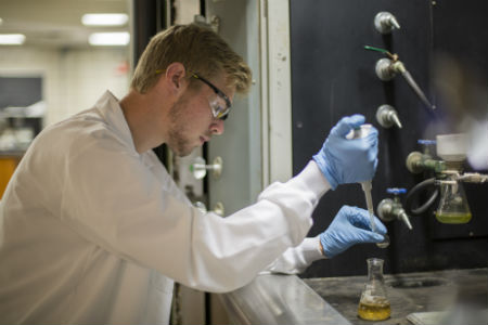Texas Wesleyan chemistry student conducts an experiment in the laboratory.