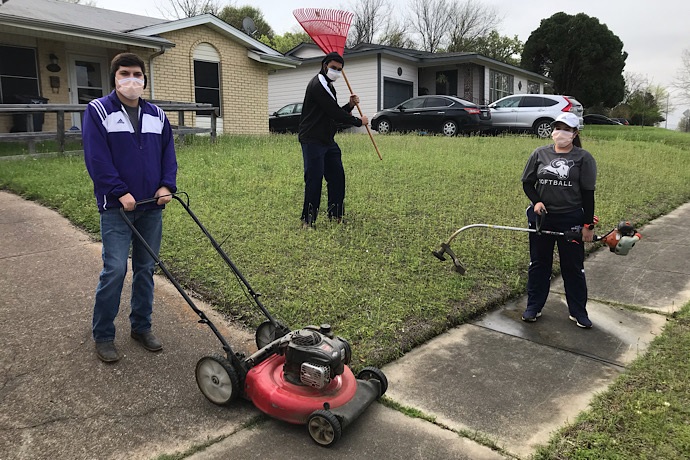 Students in yard ready to do yard work.