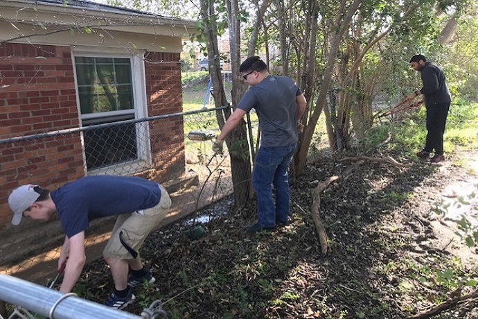 Hatton W. Sumners Scholars clean up the yard of a homebound senior in Fort Worth. N. Davis, S. Tennyson, B. Dozier. March 2019