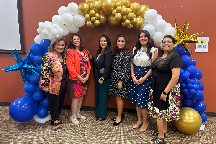 Latina Alumni Administrators Standing in front of Balloon Arch