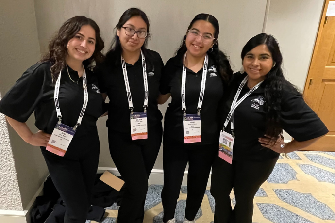 Four Texas Wesleyan students smiling at NABE