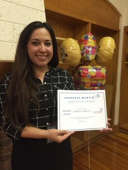 Cristina Armenta holding her award from Lockheed Martin.