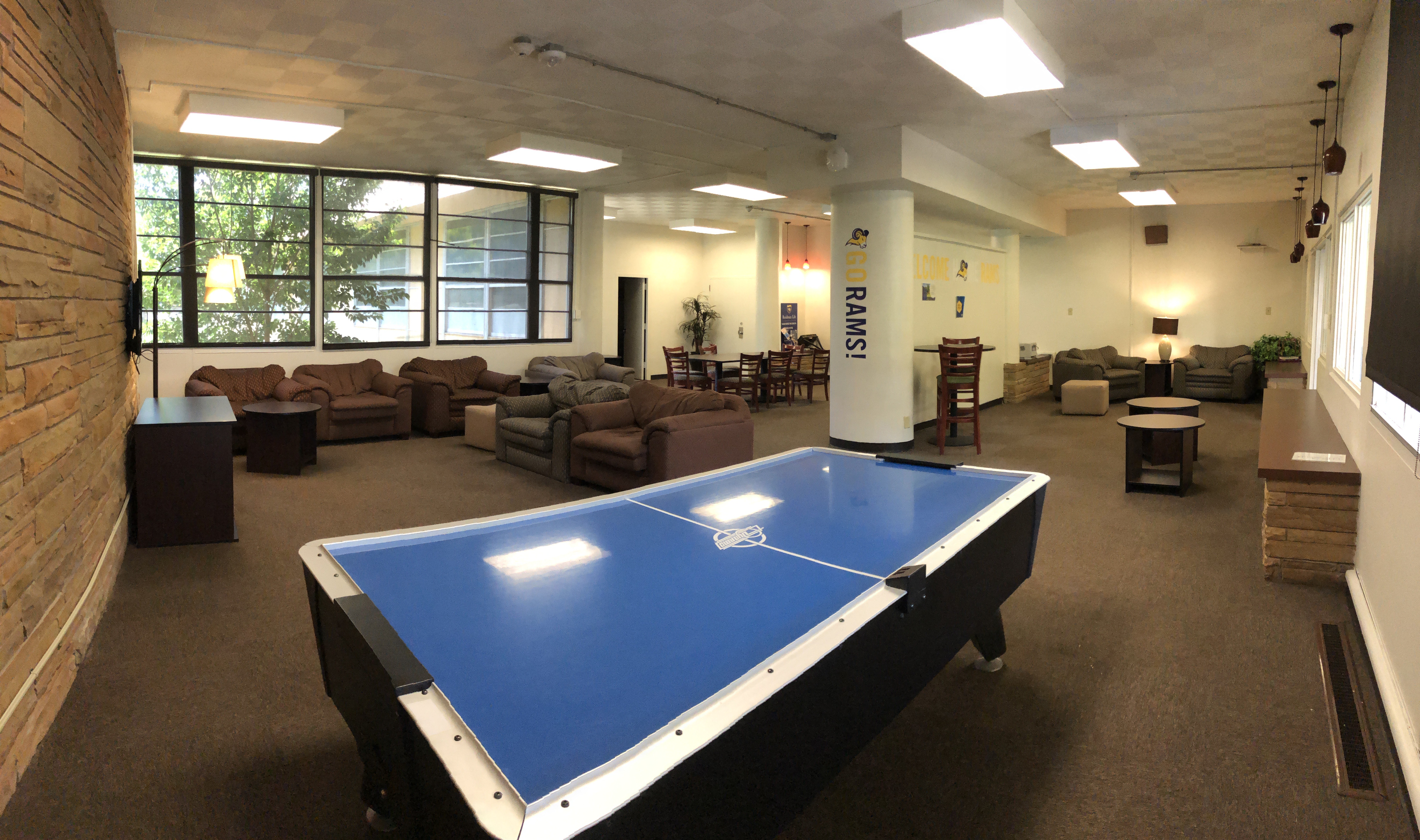 Residence hall lobby with couches, air hockey, tables