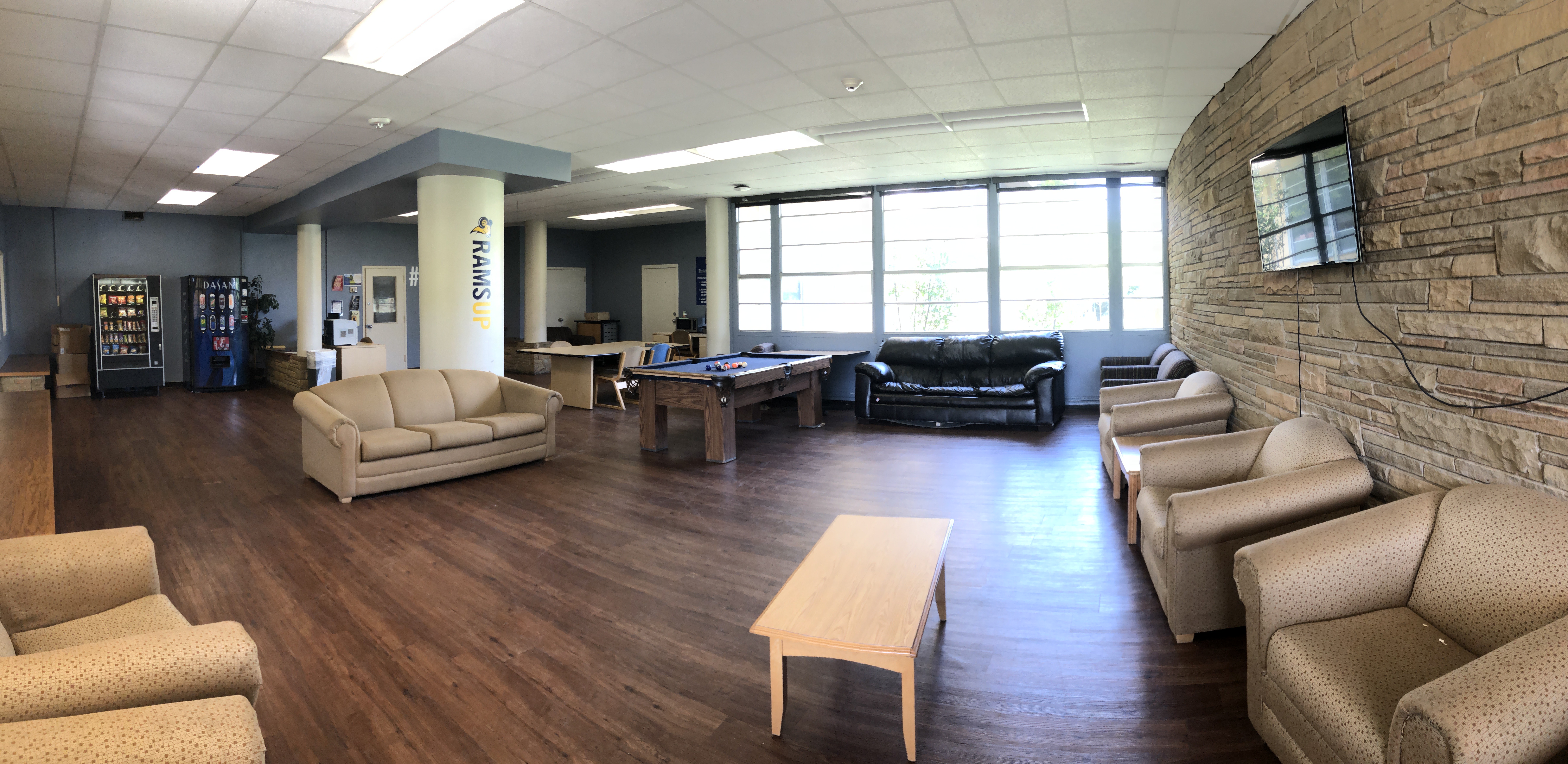 Residence hall lobby with couches, pool table, tables and vending machines