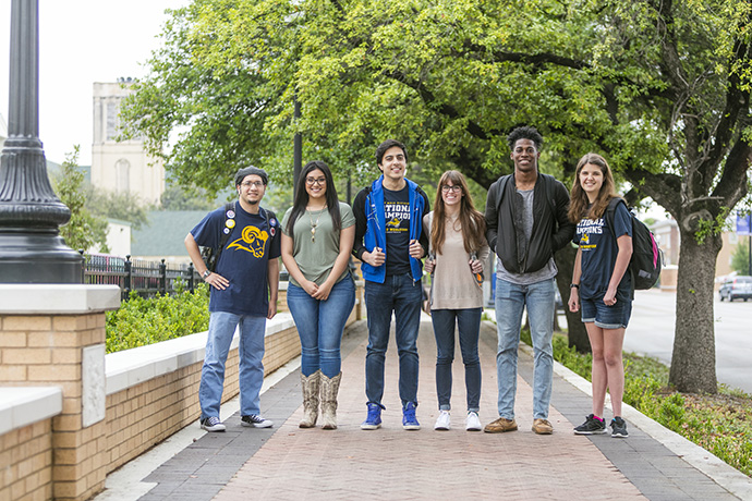 Photo of students walking together in a group on the Texas Wesleyan campus.