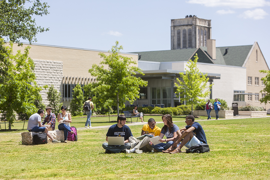 Admissions & Aid - Visit Campus. a group of students enjoying campus life outside 