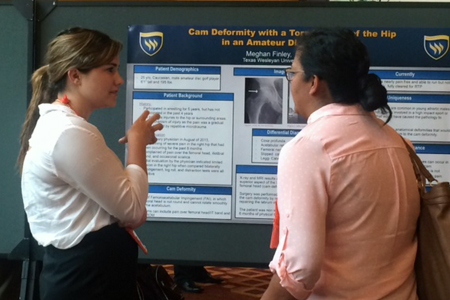 Meghan Finley presents a poster at the SWATA symposium.