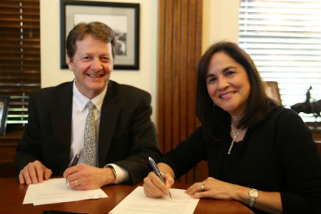 Texas Wesleyan University President Fred Slabach and Marjorie Lewis sign documents officially establishing the Marjorie Herrera Lewis Endowed Speakers Series Honoring the Fort Worth Star Telegram.