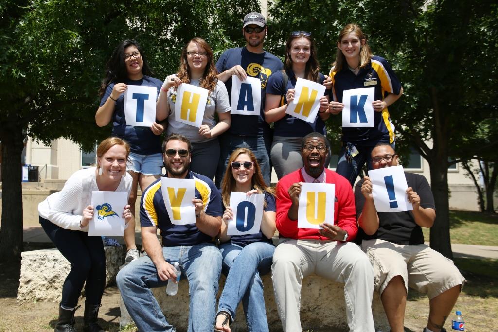 students holding thank you sign