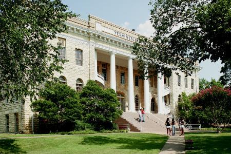 Photo with people standing in front of the Admin. Building.